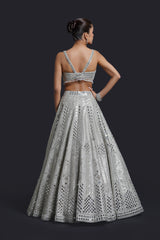 Sage green bridal lehenga blouse with mirror and pearl embroidery